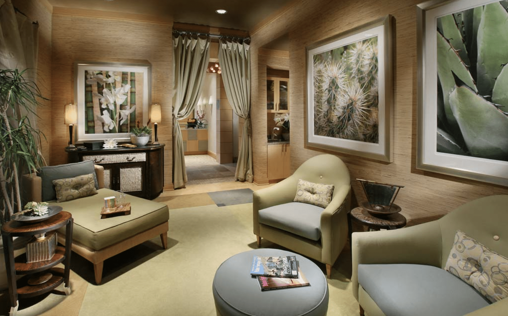 Private lounge with neutral furnishings, landscape art, and soft lighting.